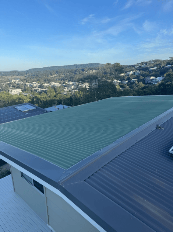 A Close Up of a Brown Gutter on the Side of a Building — Norwest Roof Restorations In Blue Bay, NSW
