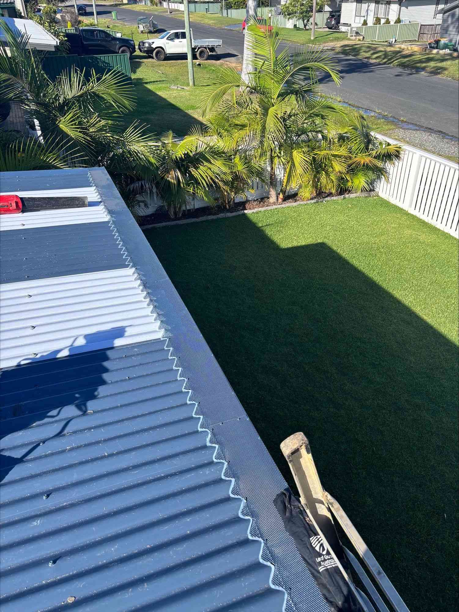 A Close Up of a Gutter With a Mesh Cover on It — Norwest Roof Restorations In Blue Bay, NSW