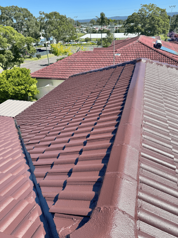 A Close Up of a Tiled Roof With a Blue Sky — Norwest Roof Restorations In Blue Bay, NSW