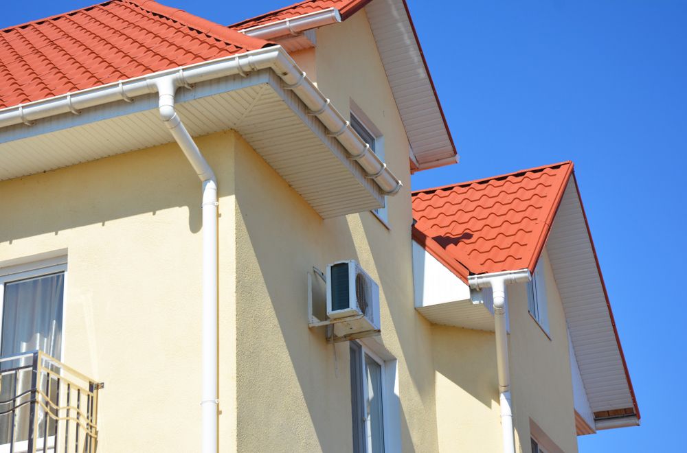 A House With a Red Roof and a White Gutter — Norwest Roof Restorations In Blue Bay, NSW