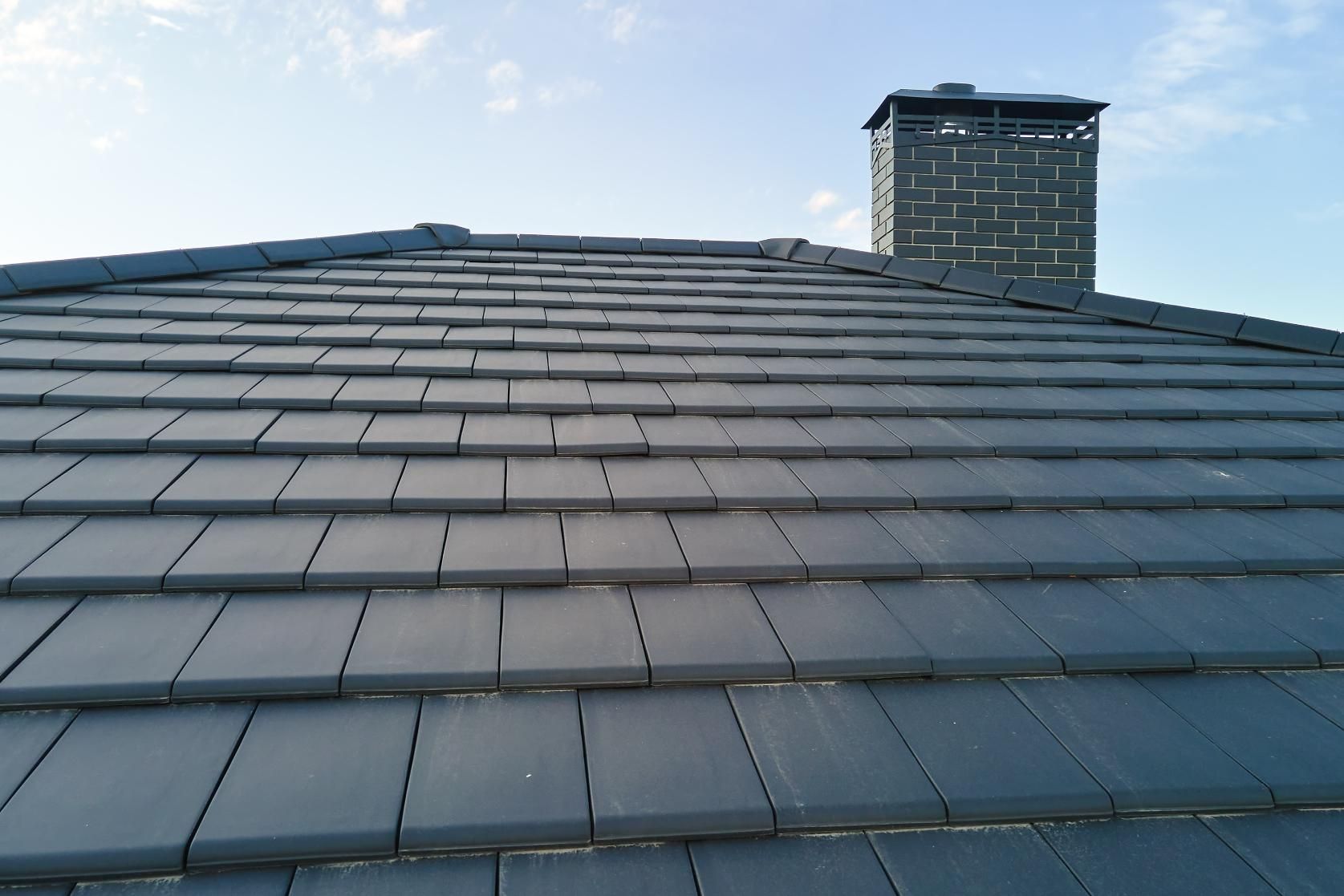 A Roof With a Chimney on Top of It — Norwest Roof Restorations In Blue Bay, NSW