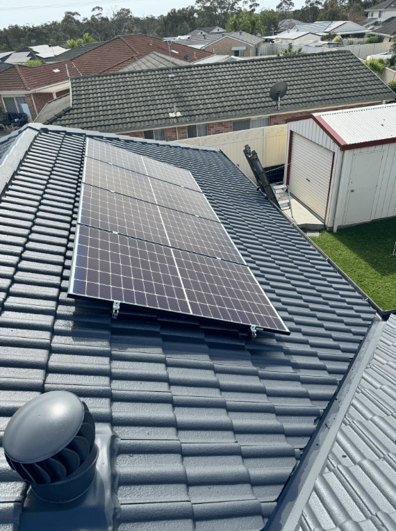 A Row of Solar Panels on a Roof — Norwest Roof Restorations In Blue Bay, NSW