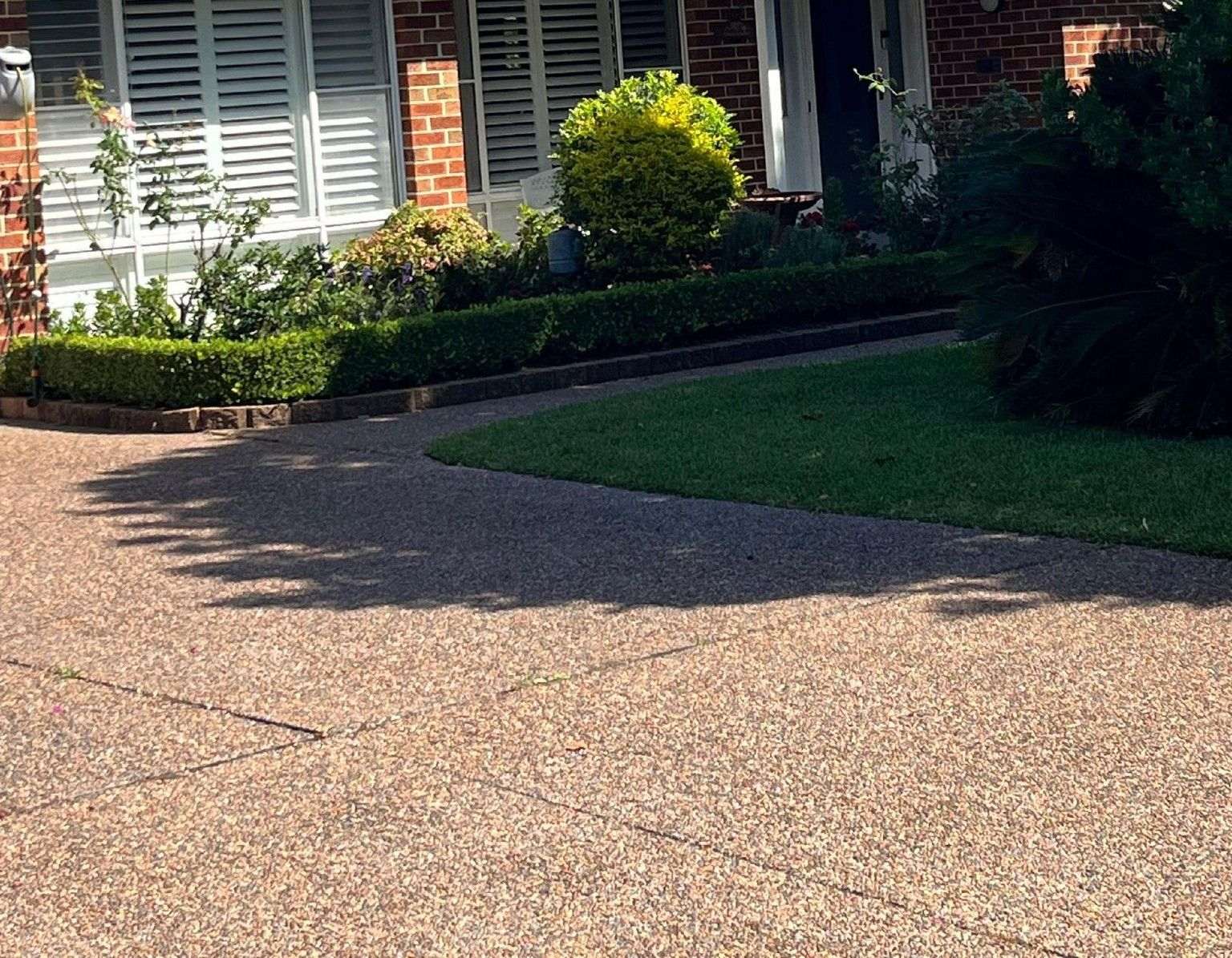 Front Yard Driveway With Textured Pavement — Norwest Roof Restorations In Blue Bay, NSW