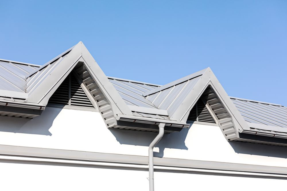 House Roof With Metal Shingles and a White Gutter — Norwest Roof Restorations In Newcastle, NSW
