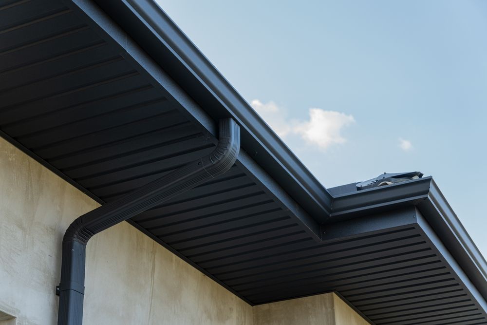 Low-angle View of a House Eave With Dark Gutters — Norwest Roof Restorations In Lake Macquarie, NSW