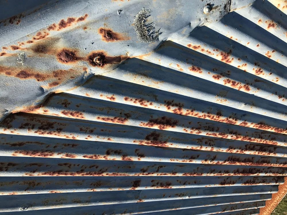 Rusty Corrugated Metal Roof With Peeling Paint and Rust Spots — Norwest Roof Restorations In Blue Bay, NSW