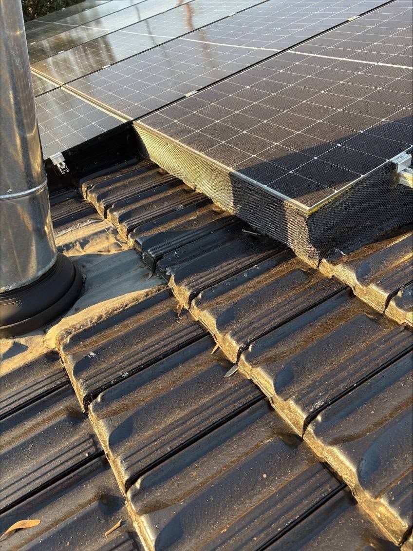 Solar Roof Tiles Around a Black Vent Pipe — Norwest Roof Restorations In Newcastle, NSW