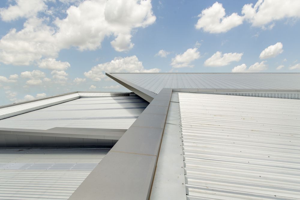 The Roof of a Building With a Blue Sky in the Background — Norwest Roof Restorations In Blue Bay, NSW